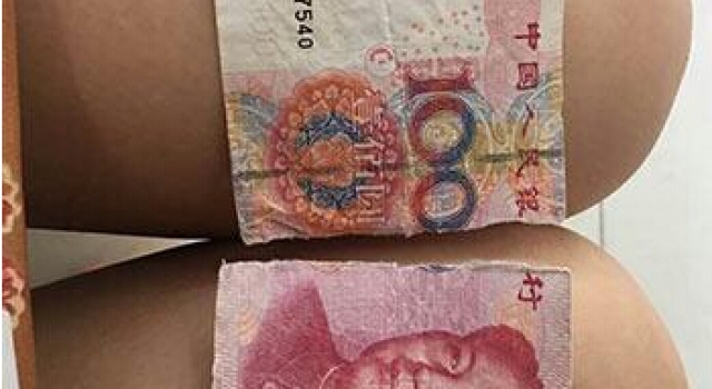 司机怒撕乘客百元钞票因疑是假钞 事后经鉴定是真钞